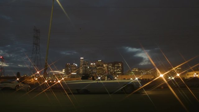 Old School Cadillac Convertible In Front Of City Skyline Folds Up Drives Off.mov