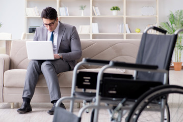 Dsabled businessman on wheelchair working home