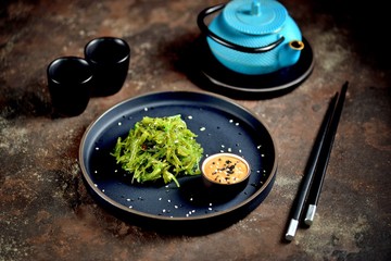 Japanese seaweed salad with nut sauce and sesame seeds.