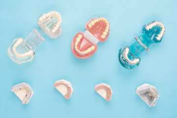 dentist tools and orthodontic on the  blue background, flat lay, top vipw.