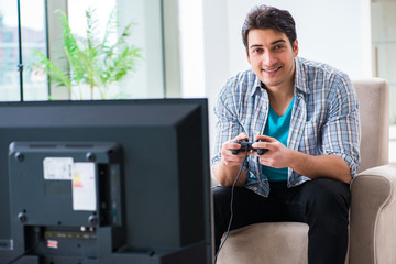 Man playing computer game at home