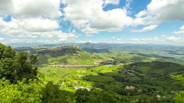 Picturesque green hilly valley near Enna city, central Sicily, Italy. The Autostrada A19 from Catania to Palermo on the background. Time Lapse