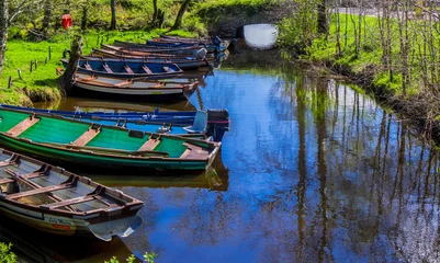Zelfklevend Fotobehang Small boats lying in a creek of Killarney National Park in Ireland © 4kclips