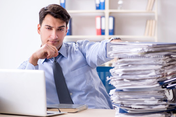 Extremely busy businessman working in office