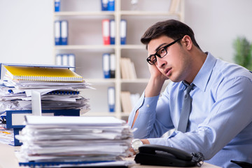 Extremely busy businessman working in office