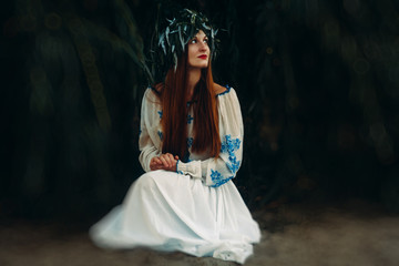 Woman in ethnic clothes with chaplet on a head