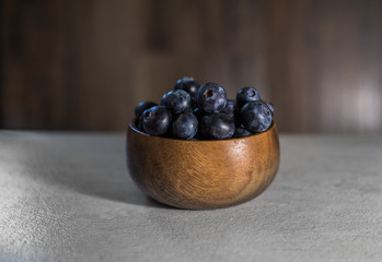 fresh blueberries in a wooden bowl