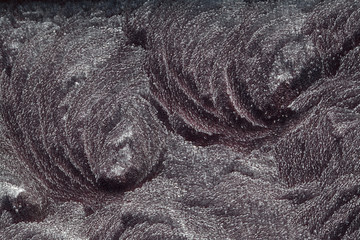 Macro view of frost patterns formed on a black background