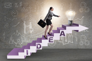 Obraz premium Concept of idea with businesswoman climbing steps stairs