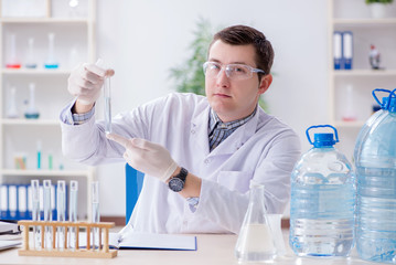 Fototapeta premium Young chemist student experimenting in lab