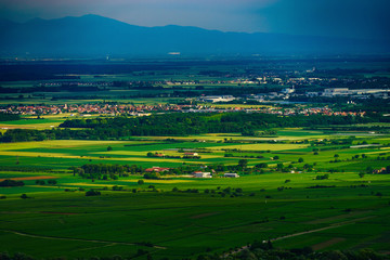 Fototapeta na wymiar Thundery weather befor the storm over the green valley in Alsace, aerial view, vivid colors