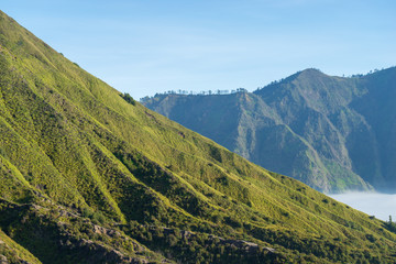 Mount Batok (2,470m), though lying adjacent to Mount Bromo. With a perfect triangular mountain top, rising from a sea of volcanic ash surrounding the Mount Bromo caldera. East Java of Indonesia.