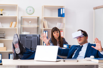 Employee with virtual reality glasses in office