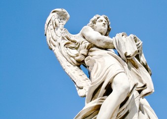 Bernini angel statue in Rome, Italy,  Ponte Sant'Angelo with bright blue sky.