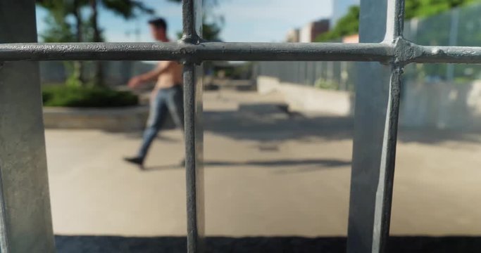 A slow daytime dolly view of unidentifiable skateboard enthusiasts at Tribeca Skatepark on lower Manhattan on a sunny summer day. Shallow DOF ensures anonymity.  	
