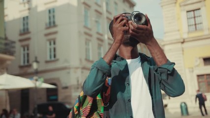 African american young man happy tourist taking photo on his camera travelling in Europe face technology handsome street urban black portrait afro close up individuality mobile phone photography