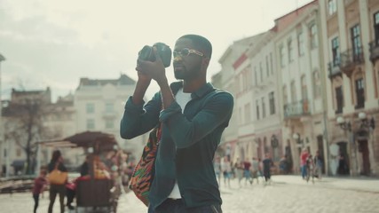 African american young man happy tourist taking photo on camera travelling in Europe face technology handsome street urban black portrait afro close up individuality mobile phone photography sunset - Powered by Adobe