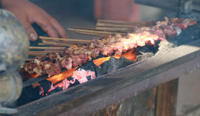 Grilling lamb satay with charcoal.