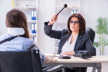 Injured employee visiting lawyer for advice on insurance