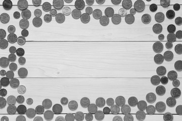Multinational coin frame on top view white wood table or floor for business background or financial exchange and investment with saving money and bank currency on mono tone or black and white