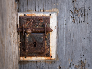 Closeup of an old rusty lock of a wooden door