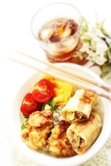 homemade spring roll and fried chicken on rice bento 