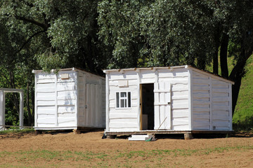 Beautiful small bathing houses on yellow sandy beach