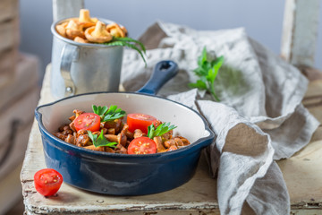 Tasty fried mushrooms with cherry tomatoes and parsley