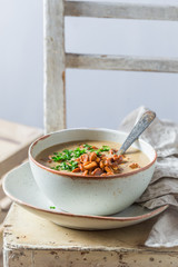 Homemade and tasty soup on old wooden table