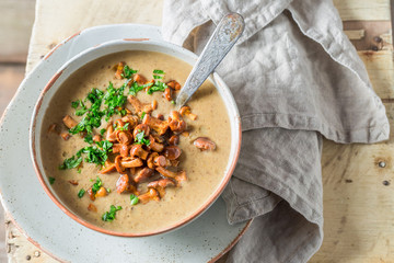 Top view of tasty mushrooms soup with chanterelles - obrazy, fototapety, plakaty