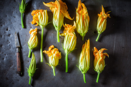 Ingredients for crispy roasted zucchini flower on metal table