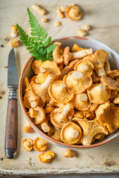 Closeup of raw chanterelles on old wooden rustic background