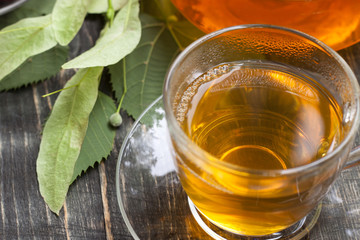 Raspberry and green tea from a linden on a wooden table