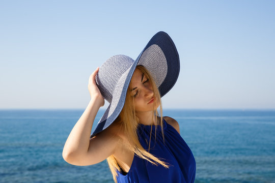 Pretty Blond Woman In The Blue Dress At The Beach In Cyprus.