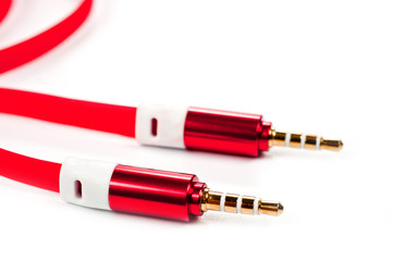 A cord with a 3.5mm bright red connector on a white background