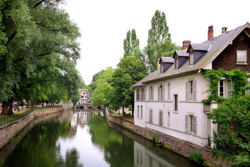 Fototapeta na wymiar Beautiful view of historic French town with traditional houses and a river in summer. Strasbourg, France.