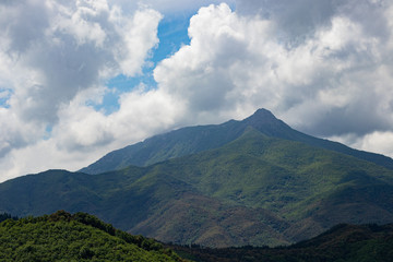 Obraz na płótnie Canvas Green mountain field landscape in Catalonia on a partially cloudy sky