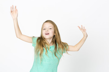 beautiful young girl is happy and dancing and posing in the studio in front of white background