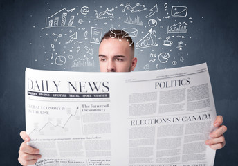 Young smart businessman reading daily newspaper with business plan graphics above his head