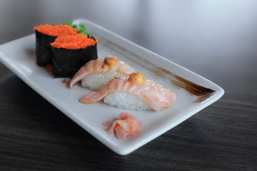 Salmon grilled nigiri sushi and Maki sushi with flying fish roe, Japanese food recipe.
