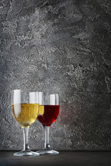 Couple glasses with red and white wine for tasting in dark cellar