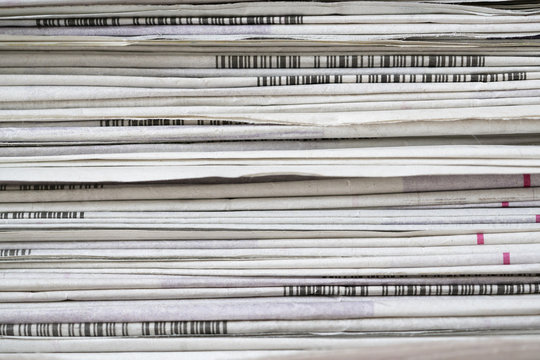close up newspapers folded and stacked background on the table