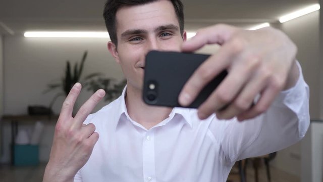 Businessman Taking Selfie with Smart phone in Office