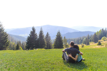 Fototapeta na wymiar Hugging Man and Woman Enjoying Landscape