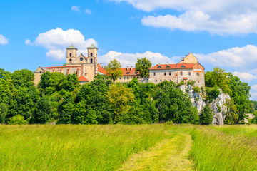 Fototapeta na wymiar View of Tyniec monastery from green fields on sunny spring day, Cracow city, Poland