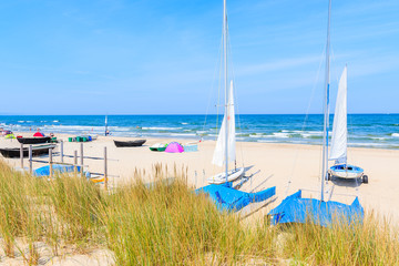 Traditional wicker chairs on sandy beach in Baabe town, Ruegen island, Baltic Sea, Germany