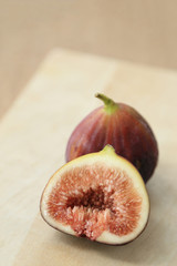 Fresh fruits, figs (Ficus carica) on the wooden plate.