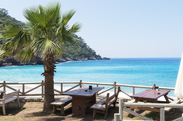 Summer open cafe on the sandy beach of the Mediterranean Sea; The concept of summer holidays or vacation on the seacoast