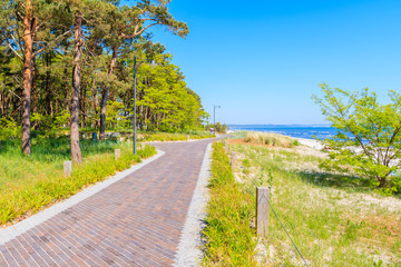 Fototapeta na wymiar Walking path along sandy beach in Prora town, Ruegen island, Baltic Sea, Germany