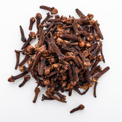 fragrant cloves on a white acrylic background
